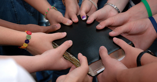 Hands holding holy book
